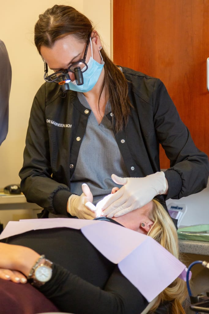 dental hygienist working on patient dental hygienist working on patient