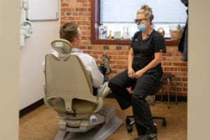 dental hygienist speaking with patient